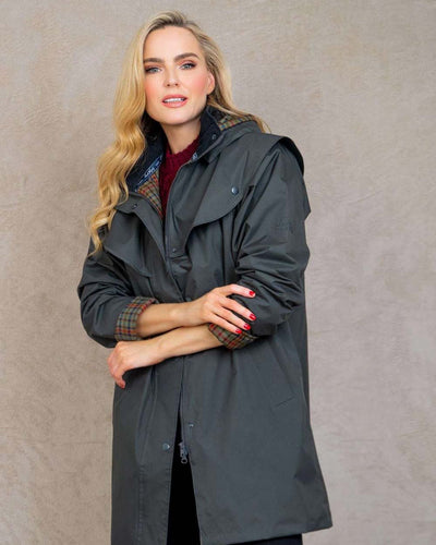 Olive coloured Jack Murphy Cotswold Ladies Waterproof 3/4 Coat on wall background #colour_olive