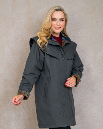 Olive coloured Jack Murphy Cotswold Ladies Waterproof 3/4 Coat on wall background #colour_olive