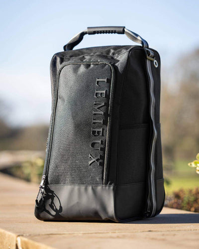 Black coloured LeMieux Elite Wellington Boot Bag on blurry background #colour_black