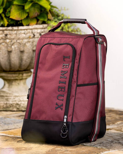 Burgundy coloured LeMieux Elite Wellington Boot Bag on plant background #colour_burgundy