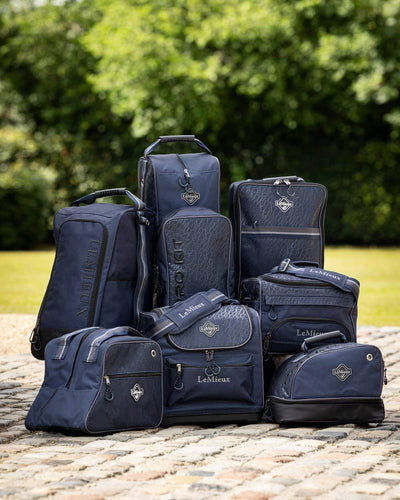 Navy coloured LeMieux Elite Wellington Boot Bag with tress in background #colour_navy